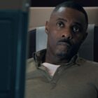 Idris Elba looking worried on a plane in Hijack.