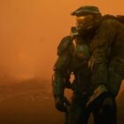 Master Chief (Pablo Schreiber) carrying a UNSC soldier over his shoulder in Halo season 2