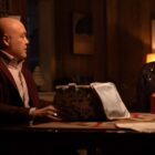 Kingpin talks to Maya at a dinner table in Echo.