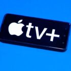 Apple TV Plus logo on smartphone on blue background