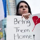 A woman holds a sign during a protest calling to bring back the hostages that were kidnaped last Saturday during Hamas' and Palestinan terrorists attack