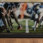 TV with Sonos Arc underneath image of football players