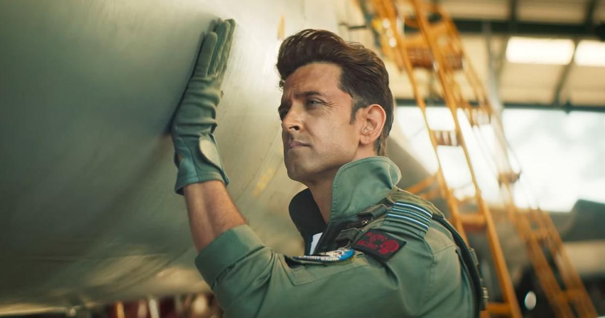 A pilot resting his hand on the outer hull of a fighter jet in Fighter.