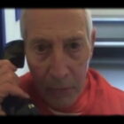 Robert Durst talks on a phone in prison in 