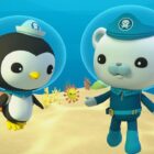 Two Octonauts wearing diving suits in the ocean.