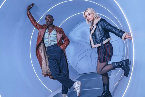 Ncuti Gatwa (Le Docteur) et Millie Gibson (Ruby Sunday) posent dans un couloir circulaire intérieur du TARDIS.