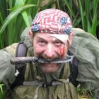 Mickey Grosman with knife in mouth