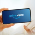 Amazon Prime Video logo on a phone being held by someone