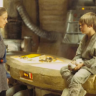a woman talks to a little boy sitting on a counter