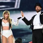 Taylor Swift is joined on stage by Travis Kelce (R), during "Taylor Swift 
