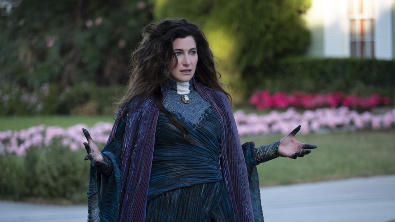 Agatha Harkness looks confused with arms outstretched in WandaVision