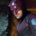 A costumed Matt Murdock smiles at someone off-camera in Netflix