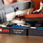 A close-up of the assembled LEGO Ideas Jaws set, showing the plaque bearing the 