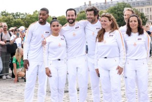 VERSAILLES, FRANCE - JULY 23: (L-R) Presnel Kimpembe, Salma Hayek, Mathieu Forget, Patrick Bruel and bearers during the Paris Olympics torch relay on July 23, 2024 in Versailles, France. Paris will host the Summer Olympics from July 26 to August 11, 2024. (Photo by Lyvans Boolaky/Getty Images)