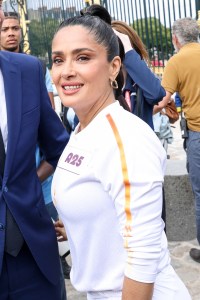VERSAILLES, FRANCE - JULY 23: Salma Hayek runs during the Paris Olympics torch relay on July 23, 2024 in Versailles, France. Paris will host the Summer Olympics from July 26 to August 11, 2024. (Photo by Lyvans Boolaky/Getty Images)