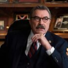 Tom Selleck as Frank Reagan sitting at desk looking serious.