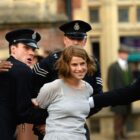 Rose Gooding (Jessie Buckley) being arrested by police officers in 