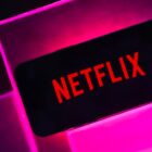 Netflix logo in a pink box surrounded by black background