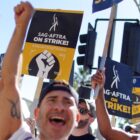 LOS ANGELES, CALIFORNIA - NOVEMBER 08: SAG-AFTRA members and supporters chant outside Paramount Studios on day 118 of their strike against the Hollywood studios on November 8, 2023 in Los Angeles, California. A tentative labor agreement has been reached between the actors union and the Alliance of Motion Picture and Television Producers (AMPTP) with the strike set to end after midnight. (Photo by Mario Tama/Getty Images)