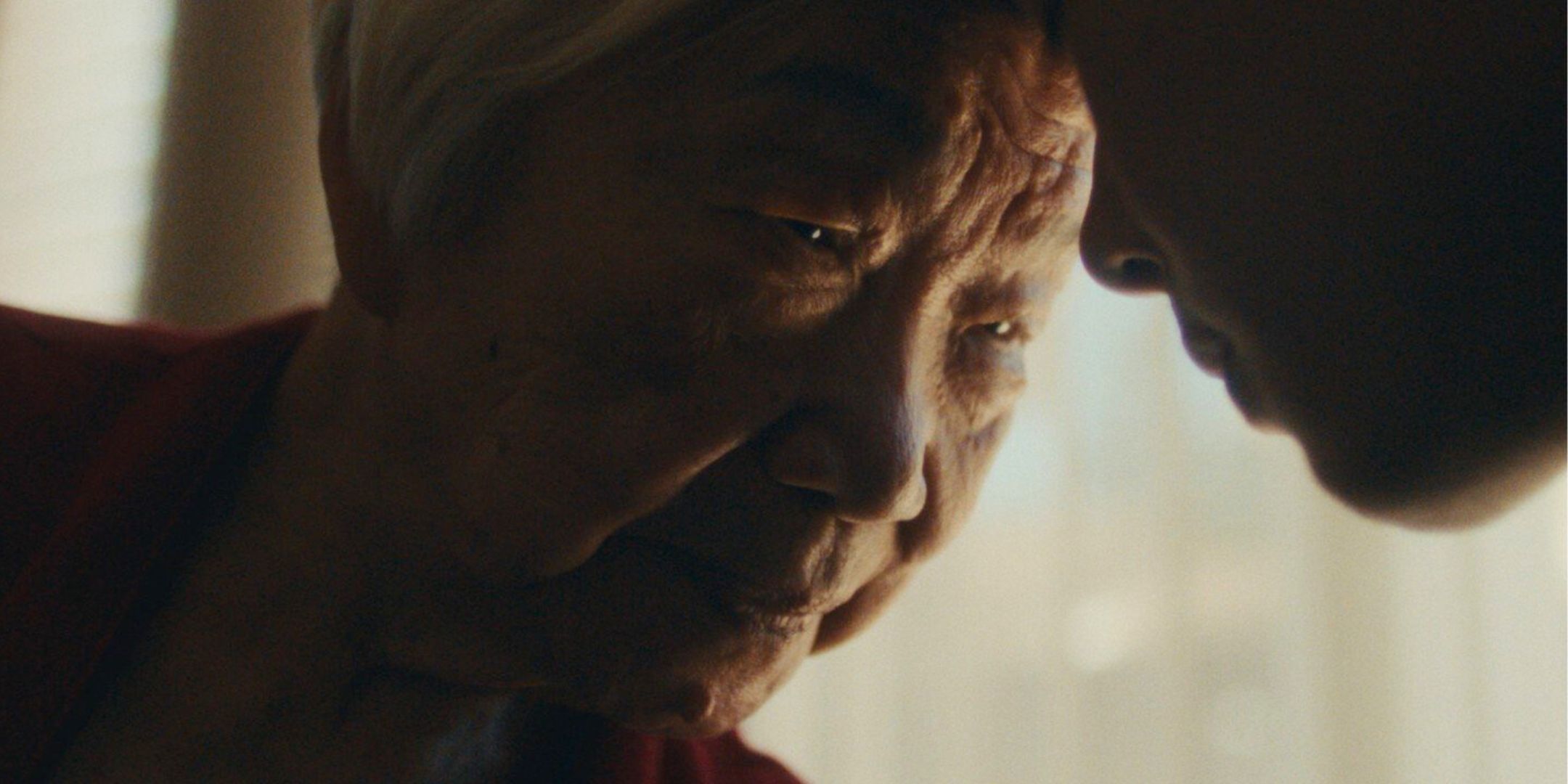 Nǎi Nai pressing forehead with Wài Pó in Sean Wang's short Disney+ documentary.