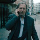 Jackson Lamb walks as he talks on the phone in Slow Horses season 4
