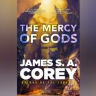 The cover of The Mercy of Gods by James S.A. Corey, author of The Expanse. The cover has a science-fiction style city set into towering cliffs and a yellow sky above it.