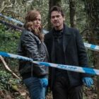 DCI Jeanette Kilburn (Eve Myles) and DI Lou Stanley (Dougray Scott) stand in a woodland crime scene in "The Crow Girl"