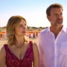 Francesca looks up and smiles at Eric while he looks off into the distance in La Dolce Villa.