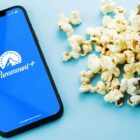 Paramount Plus app on a phone next to popcorn