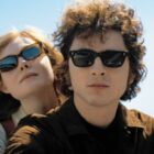 (L-R) Elle Fanning as Sylvie Russo and Timoth&eacute;e Chalamet as Bob Dylan as "A Complete Unknown"
