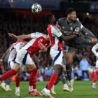 LONDON, ENGLAND - APRIL 08: Jude Bellingham of Real Madrid shoots at goal whilst under pressure from Thomas Partey of Arsenal during the UEFA Champions League 2024/25 Quarter Final First Leg match between Arsenal FC and Real Madrid C.F. at Emirates Stadium on April 08, 2025 in London, England. (Photo by Justin Setterfield/Getty Images)
