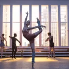 A female dancer in class performing an attitude derriere en pointe.