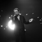 Bono on stage in Apple TV Plus' Bono: Stories of Surrender.