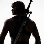 Nicholas Galitzine as He-Man with his back to the camera