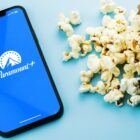 Paramount Plus app on a phone next to popcorn