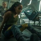 Gaal sits and gasps for breath as Demerzel kneels behind her on a spaceship in Foundation season 3 episode 6