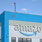 Amazon company logo with damaged letter 'n' on warehouse office building in Red Hook, Brooklyn, New York City