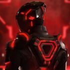 A headshot featuring a figure in a black with red accents suit, from TRON: Ares