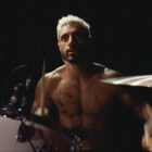 A still from the movie Sound of Metal showing Riz Ahmed's character Ruben playing the drums.