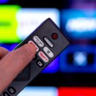 Philips TV remote pointed at television filled with apps