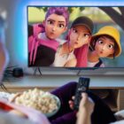 Woman watching KPop Demon Hunters on TV
