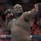 Derrick Lewis pretending to draw a bow and fire an arrow. 