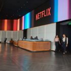A spacious lobby with the Netflix logo above the reception desk.