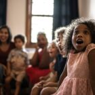 A child is showing surprise while watching a show.