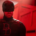 Daredevil wearing his black suit in a red-lit room in Daredevil: Born Again season 2