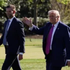 US President Donald Trump waving as he walks with his eldest son Donald Trump Jr., on April 10.