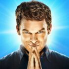 Dexter puts his hands together in a prayer position in front of his face