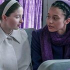 Daisy and Agnes sit next to each other on the plum bus