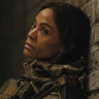 Zoe Saldana sits slumped against the wall