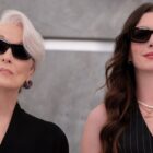 Miranda and Andy stand side by side wearing sunglasses